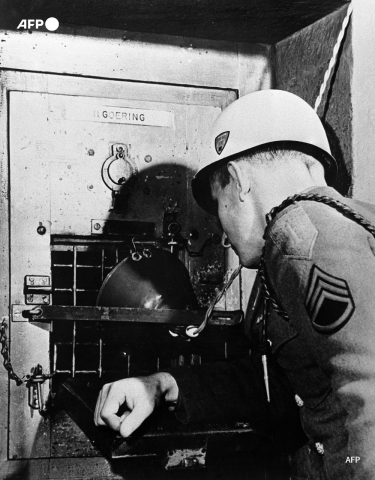 A US army sergeant looks into Hermann Goering's prison cell in Nuremberg in December 1945 - AFP
